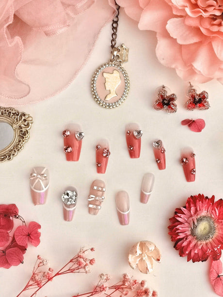 Che Naildid Pink press on nails with a barbie badge. Fancy Nails with bow and diamons.