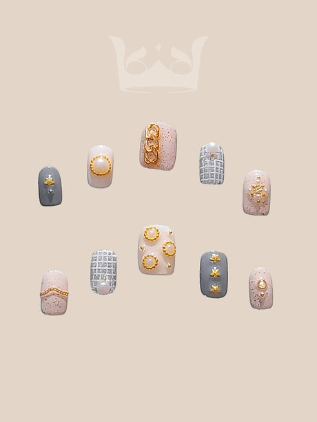 Luxurious nails with a monochromatic color scheme, featuring pearls, rhinestones, geometric patterns, 3D elements, and mixed textures for a high fashion statement.