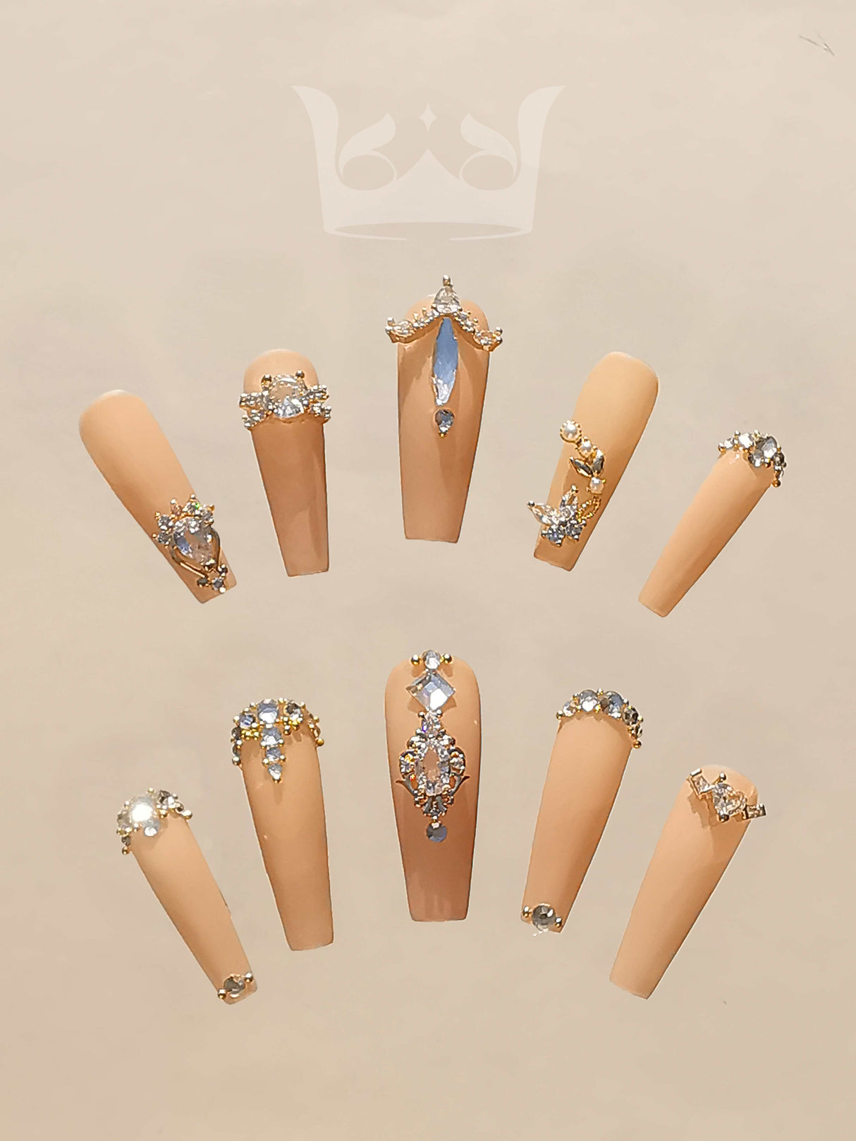Luxurious and high-fashion inspired nails with black, white, and gold color scheme, 3D jeweled effects, chain and bow designs, and pearls.