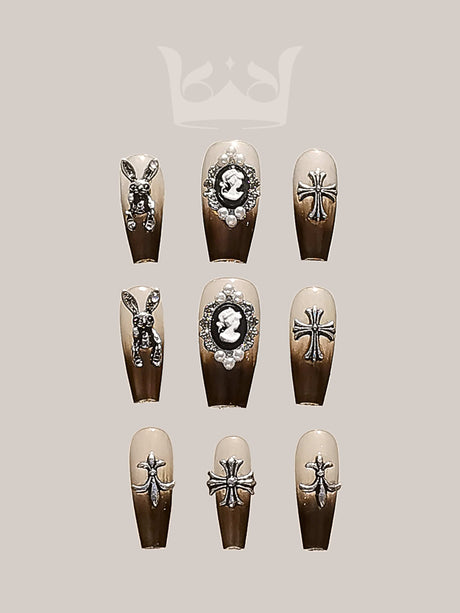 Luxurious and trendy nails with neutral base color and embellishments suitable for special occasions or fashion statements, featuring rhinestones and metallic insect motifs.
