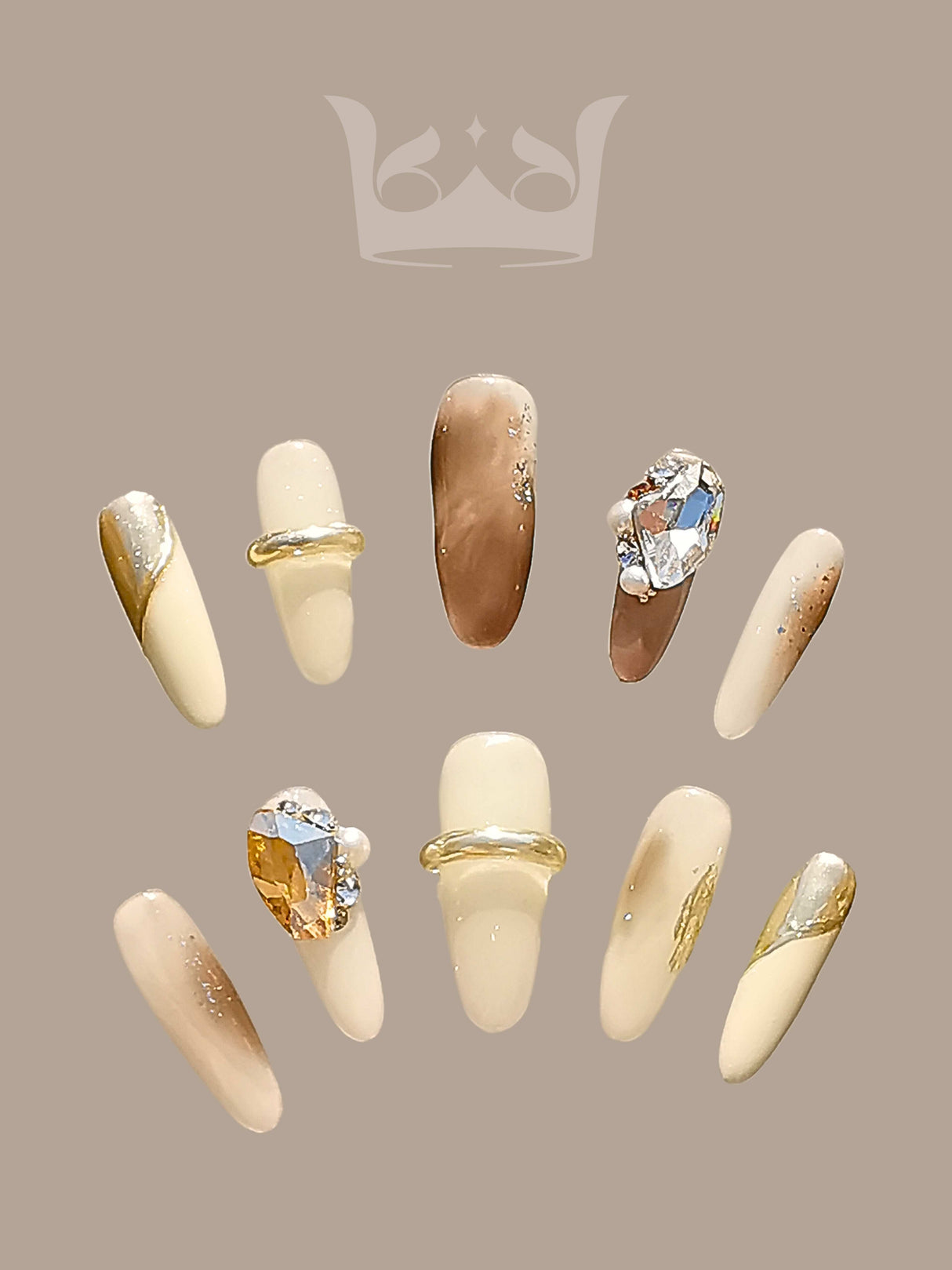 Chic and modern nails with luxurious details, including rhinestones, gold accents, and a gold band. Ideal for special occasions or fashion statements.