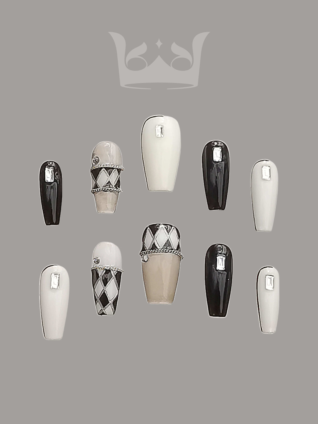 Luxurious and high-fashion-inspired nails with black, white, and gold color schemes, 3D jeweled effects, chain and bow designs, pearls, and add a touch of luxury and sophistication to any outfit.