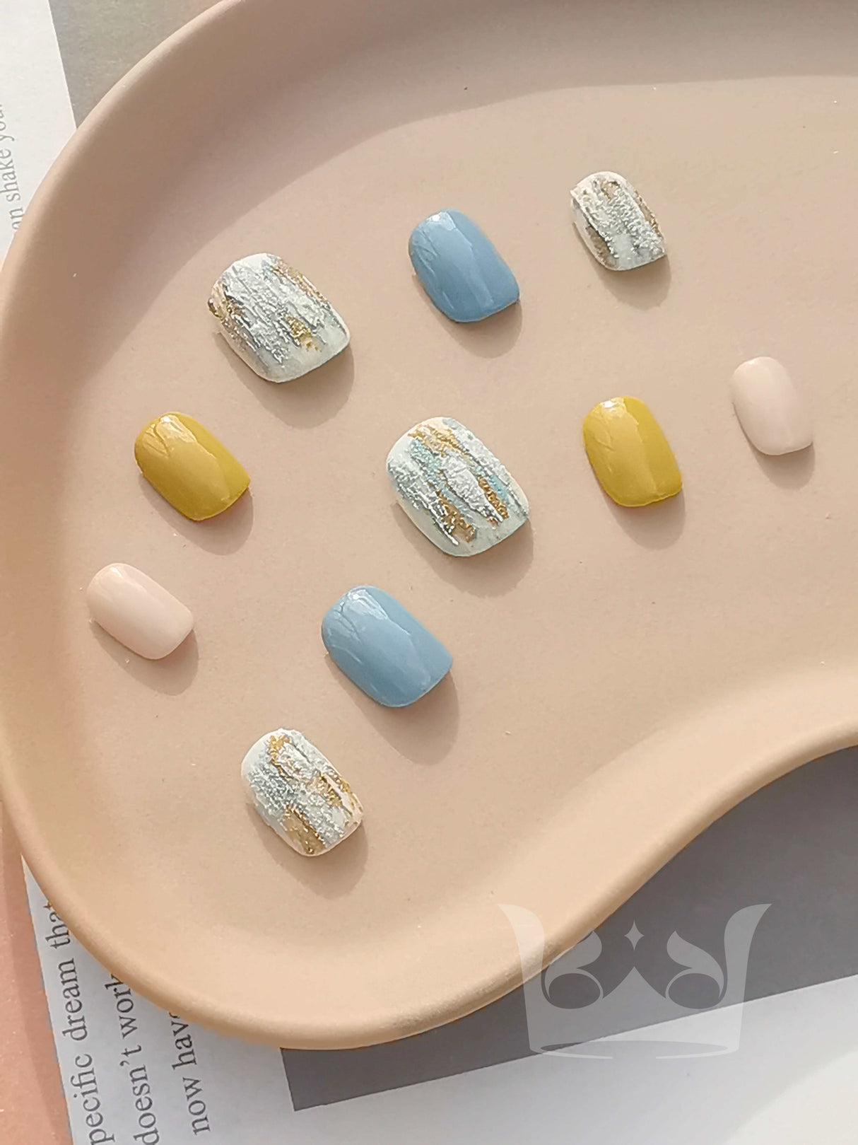Press-ons feature round shapes, pastel watercolor colors, textured, and minimalist style. Monet's painting inspired nail design.