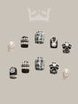 Luxurious and ornate nails with pearls, beads, geometric patterns, jewel embellishments, mixed textures, accent nail, and symmetry for a bold fashion statement or special occasion.