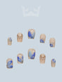 These press-on nails have a marbled blue and white design with golden bead embellishments and a glossy finish. Ideal for those who enjoy artistic and elegant designs with a touch of glamour.