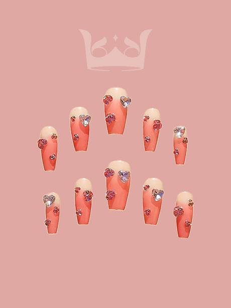 Heart-shaped nails with peach/nude base, metallic/glittery finish & silver/purple/pink hues add a playful & romantic touch to any look, perfect for Valentine's Day or whimsical events.