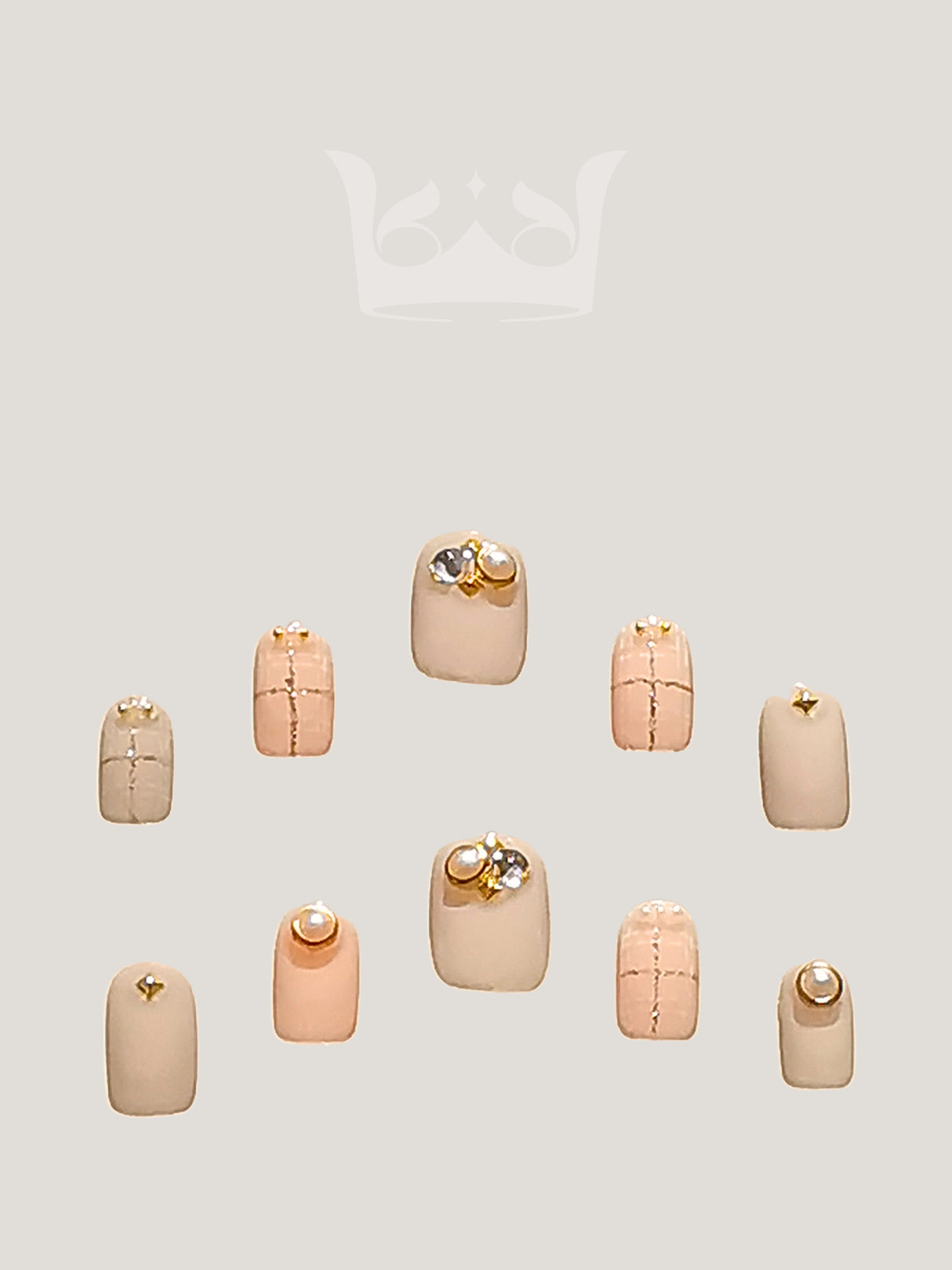 Cute nails for enhancing natural nails, suitable for salons or personal use. Soft pink with metallic gold accents and embellishments for elegance.