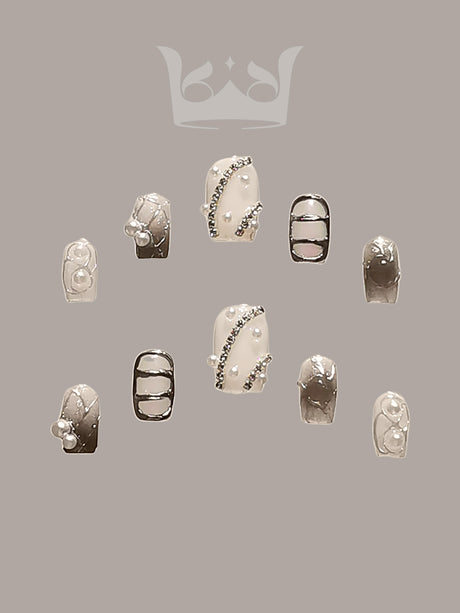 Luxurious and statement nails for special occasions with neutral/nude base, embellishments, 3D elements, metallic accents, and French tips for a fancy look.