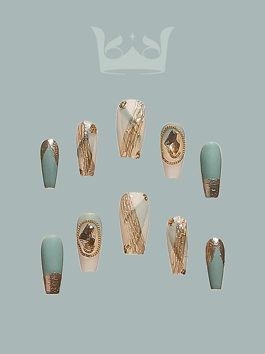 These press-on nails are for special occasions or fashion shows, with gold foil accents and unique designs for a fancy audience.