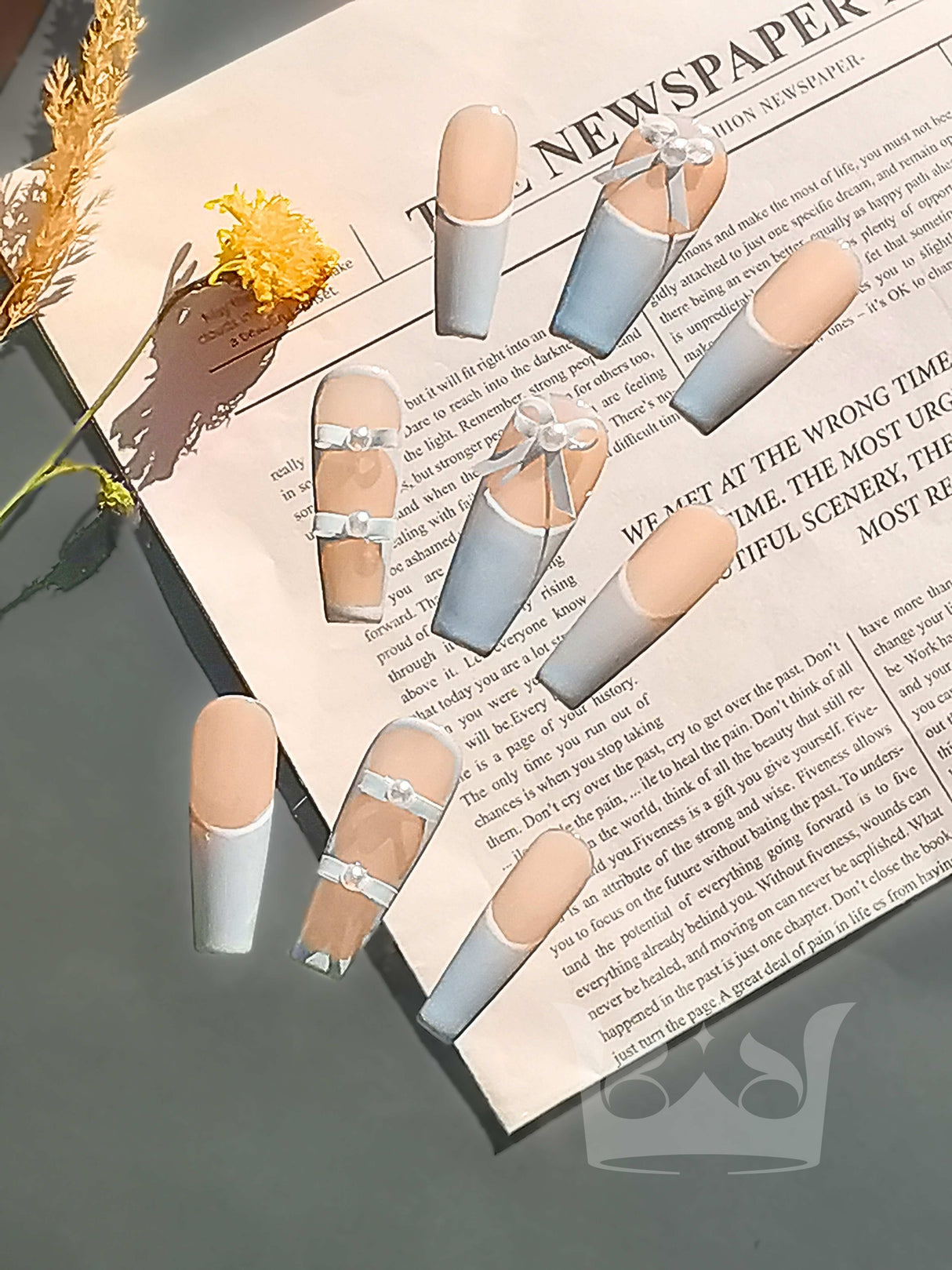 These press-on nails feature a French manicure with a clear cute element resembling a bow or ribbon, suitable for special occasions or everyday wear.