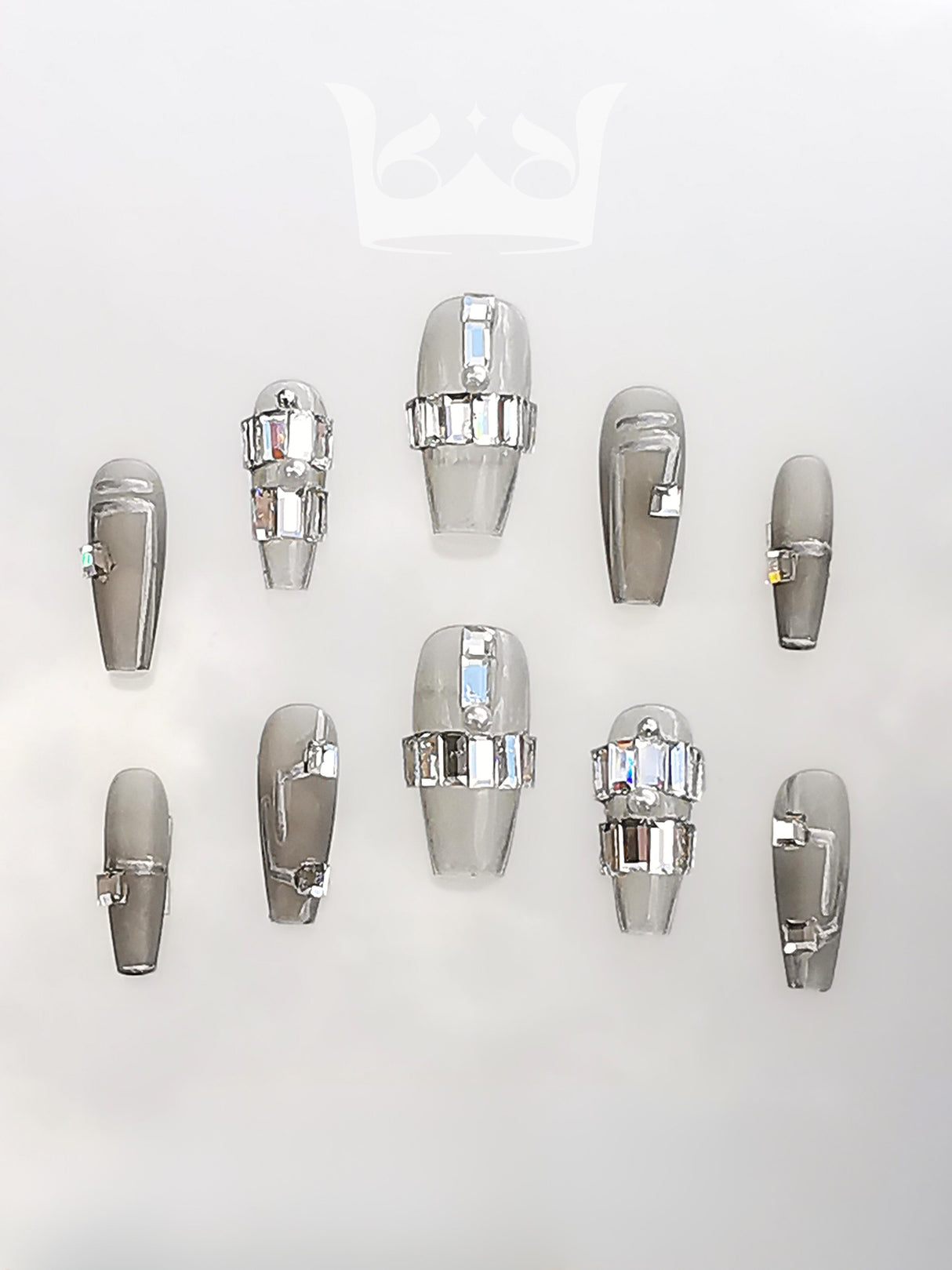 Luxurious and bold nails with a monochromatic color scheme of black, white, and silver, featuring pearls, rhinestones, patterns, textures, glitter, metallic accents, and a camellia flower design