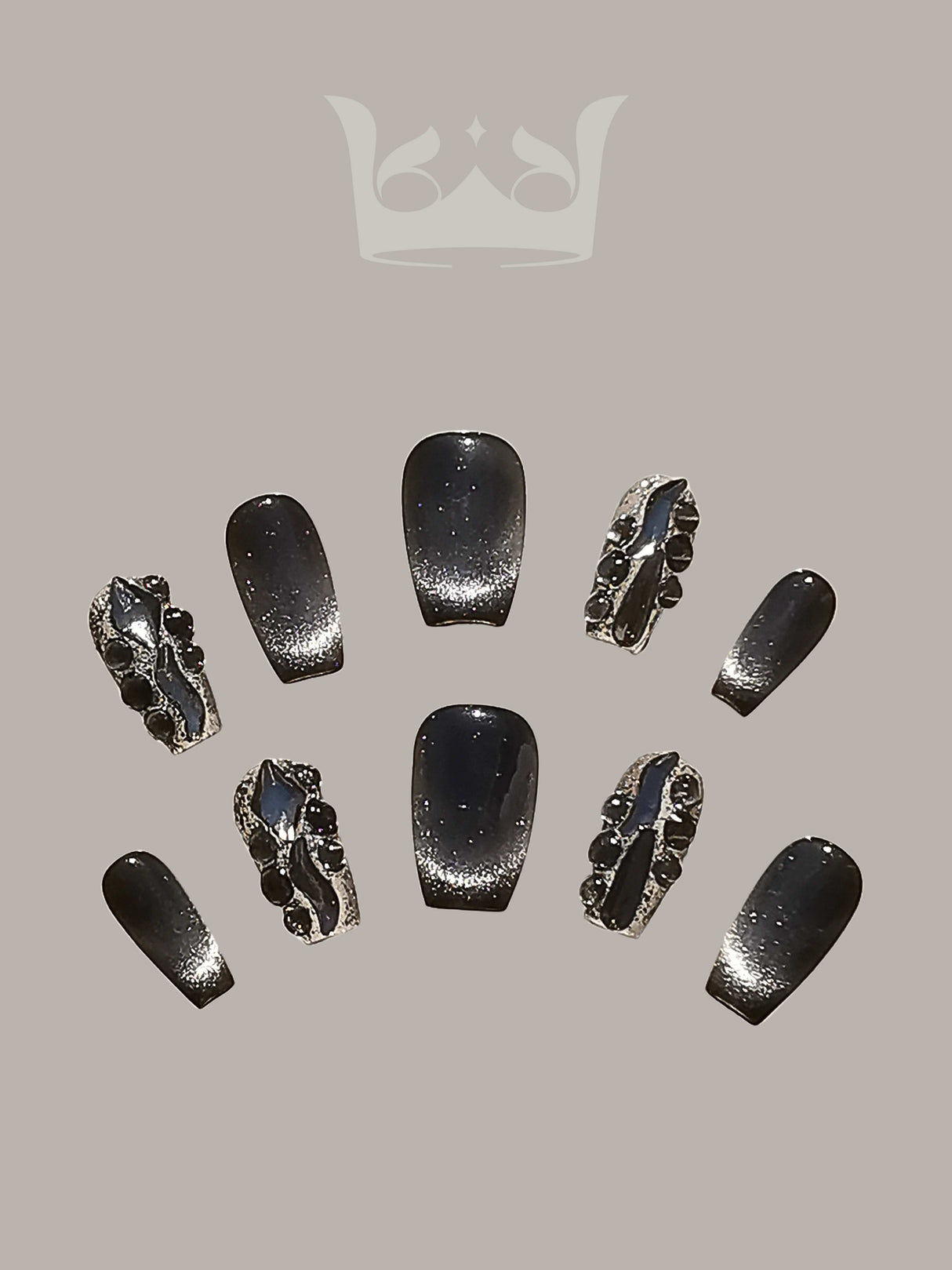 These acrylic nails are for cosmetic enhancement and decoration of natural nails with a dark, glittery finish and metallic or jeweled accents.