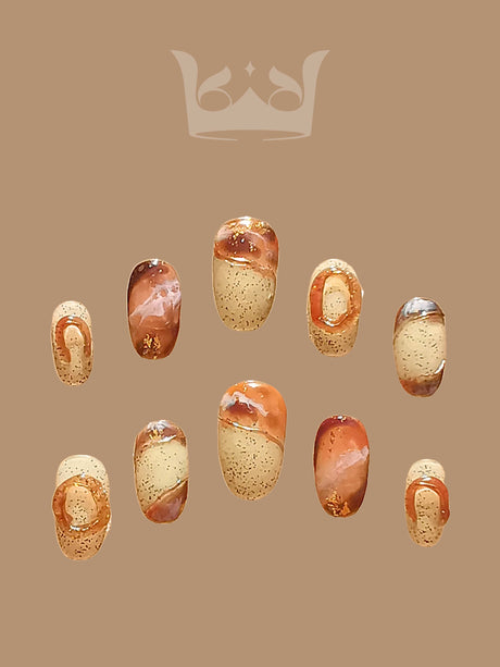 Oval medium-length press-ons with hand-painted marble effect. Painted with a netruel color pallate and stone-like background with sculpted rings.