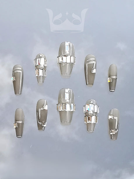 These high-end fashion nails are for those who want to make a statement with trendy designs, pearls, rhinestones, and chains.