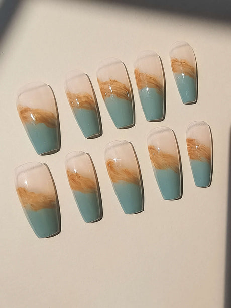Long, dual-tone nails with a marbled pattern resembling natural stone or marble, in a coffin or ballerina shape, for those who want a stylish accessory.