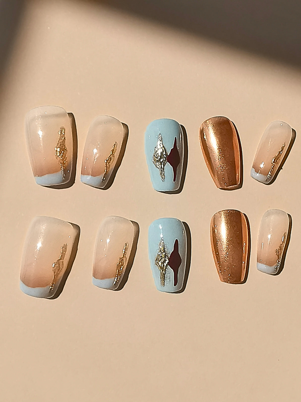 These press-on nails have an ombre design with gold accents and varying sizes for a better fit. They're suitable for special occasions or everyday wear.