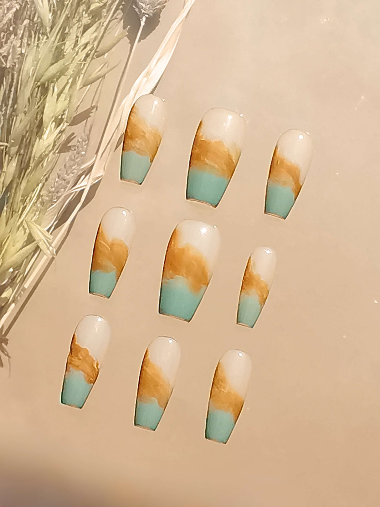These long, coffin or ballerina-shaped nails feature a layered, abstract design resembling a landscape or geode. They are ideal for adding an artistic touch to a manicure.