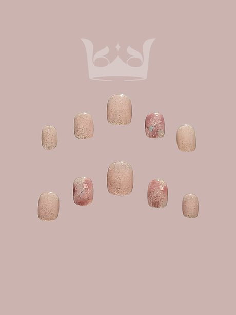 Custom-designed nails with a neutral base color, gold accents, geometric pattern, and textured design for a fancy and elegant look.