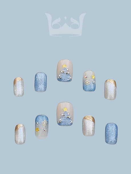 These press-on nails are perfect for winter or holiday events, featuring pastel blue and white colors, snowflake designs, rhinestones, and artistic details.