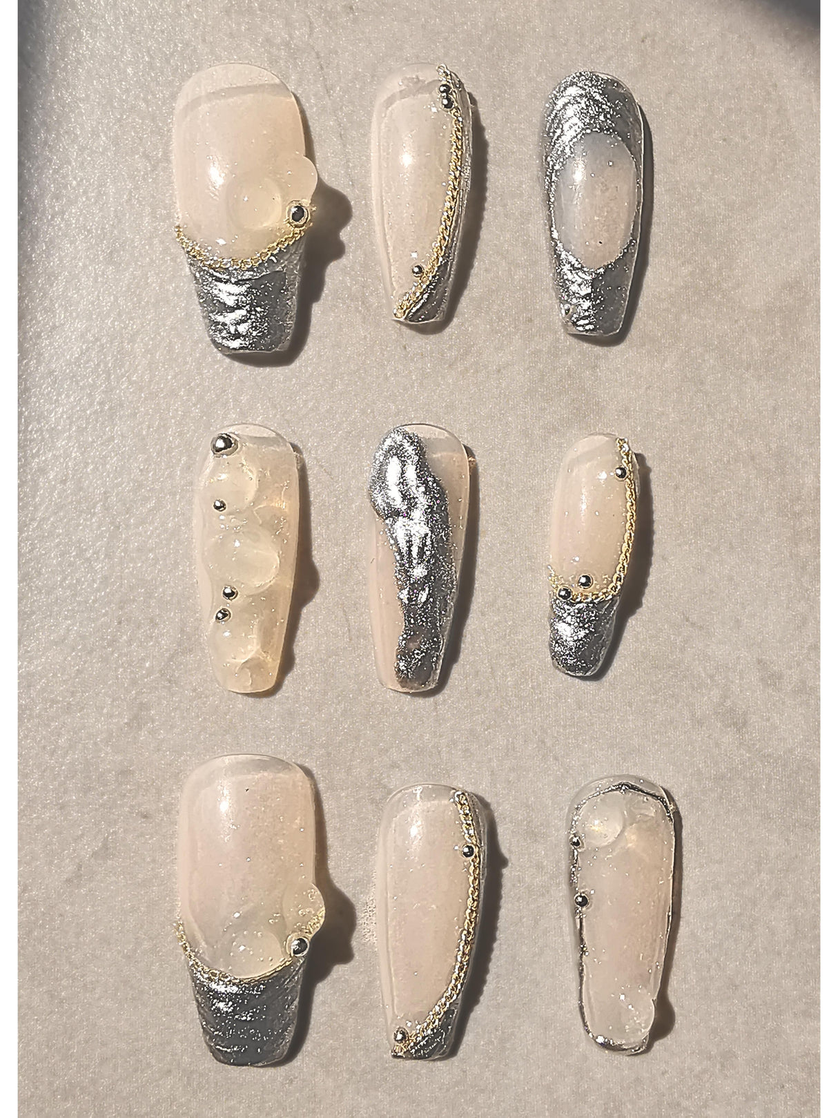 These press-on nails are designed for special occasions or fashion statements, with elaborate designs including accent features, embellishments, texture, unique shape, and glossy finish.