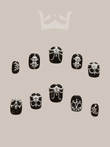 These press-on nails with floral motifs and hanging jewels are for a formal event or fashion statement. Varying sizes fit different nails for a complete set.