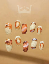 Oval medium-length press-ons with hand-painted marble effect. Painted with a netruel color pallate and stone-like background. Best nail art design in 2024.