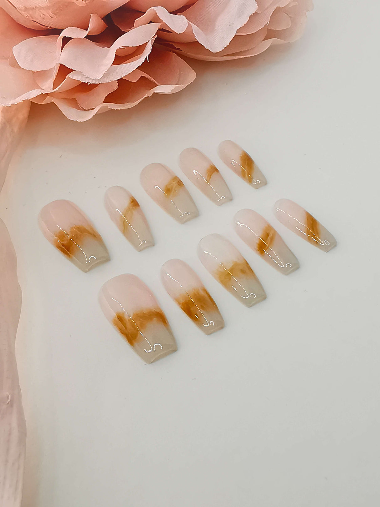 Luxurious and unique nails with ombre effect, marbling, gold foil accents, and long coffin/ballerina shape for special occasions or statement-making looks.