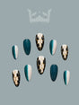 These press-on nails have a fancy and stylish design with a deep teal and white color palette, featuring color blocking, geometric patterns, and a glossy finish.