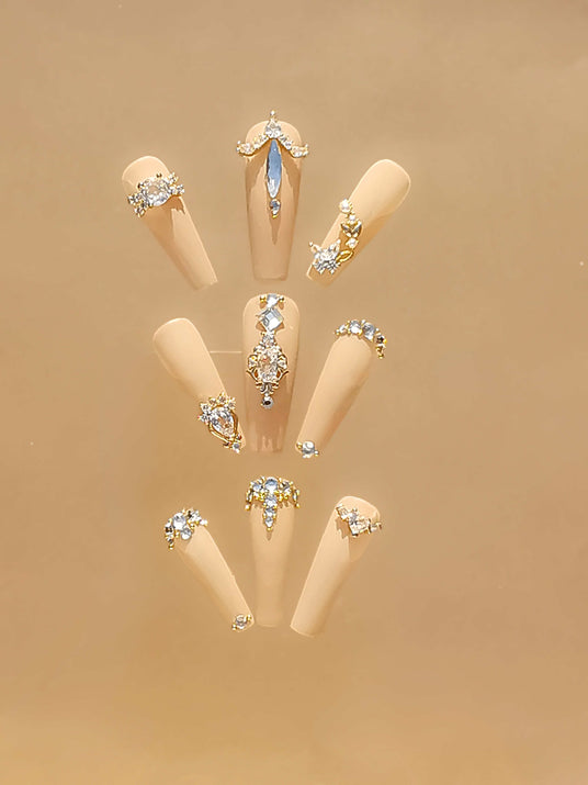 Luxurious and glamorous nails with trendy handcrafted nail art, incorporating rhinestones and crystals in different patterns, suitable for special occasions.