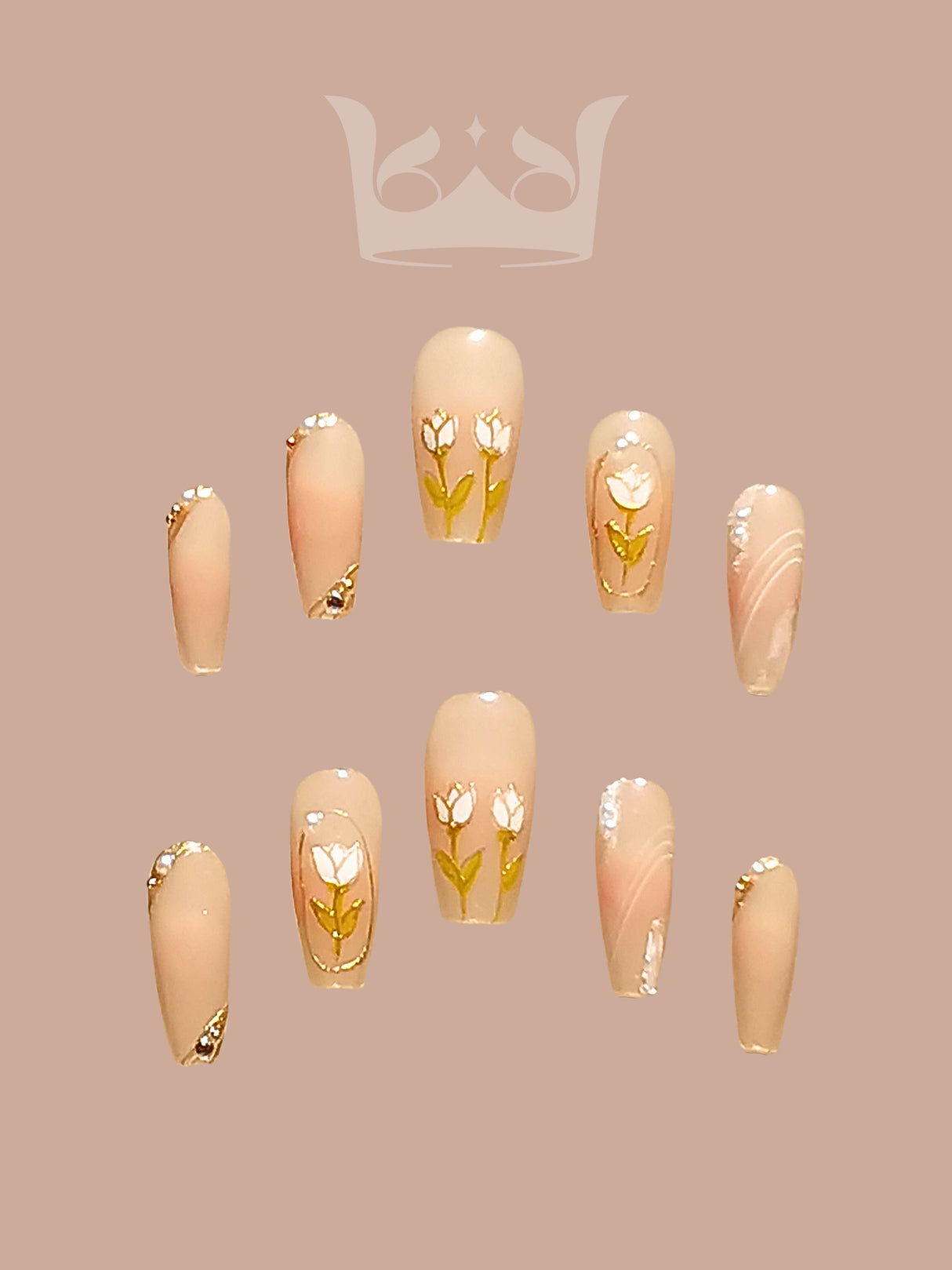 These press-on nails are perfect for special occasions, with a soft neutral base color, delicate floral art, gold accents, marbled effect, and glossy finish. 