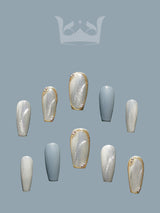 These press-on nails are perfect for a special occasion with a unique design featuring a two-tone effect, gold embellishments, and a coffin/ballerina shape. The glossy topcoat adds a polished finish.