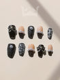 These black and nude nails with textured and embellished elements are for special occasions, appealing to those who want a bold and fancy look.