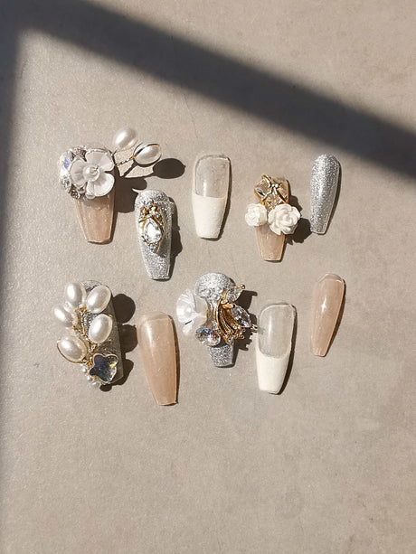 These press-on nails have a neutral color palette and ornate embellishments suitable for weddings and formal events. The coffin/ballerina shape adds to their aesthetic appeal.