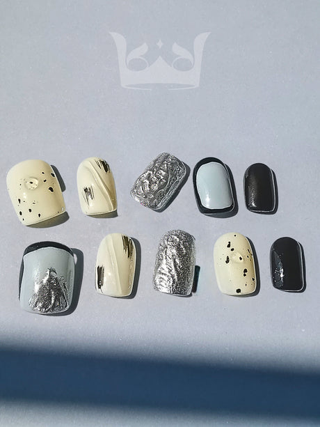These press-on nails are designed for nail art with a monochromatic color scheme, different finishes, patterns, and sizes for a fashionable and bold statement.