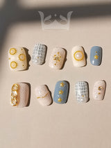 Luxurious nails with a monochromatic color scheme, featuring pearls, rhinestones, geometric patterns, 3D elements, and mixed textures for a high fashion statement.