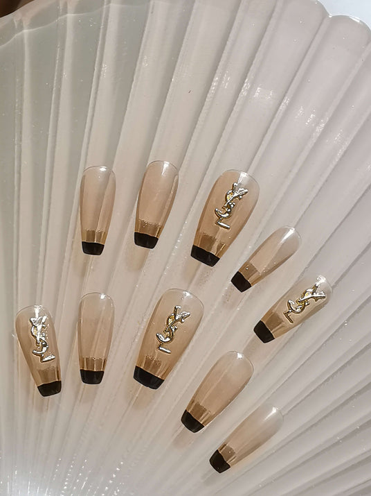 These elegant and trendy coffin-shaped nails with gold accents are perfect for special occasions and those who want to make a statement with their nails.