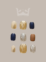 These press-on nails have a color palette of gold, beige, white, and navy blue, with marble/fluid art designs and metallic/foil finish for a fancy and modern look.