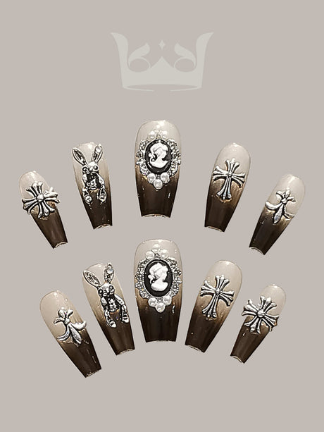 These press-on nails are designed for special occasions, featuring trendy designs with cameo, rhinestone, metallic, and insect motifs, and a glossy finish. 