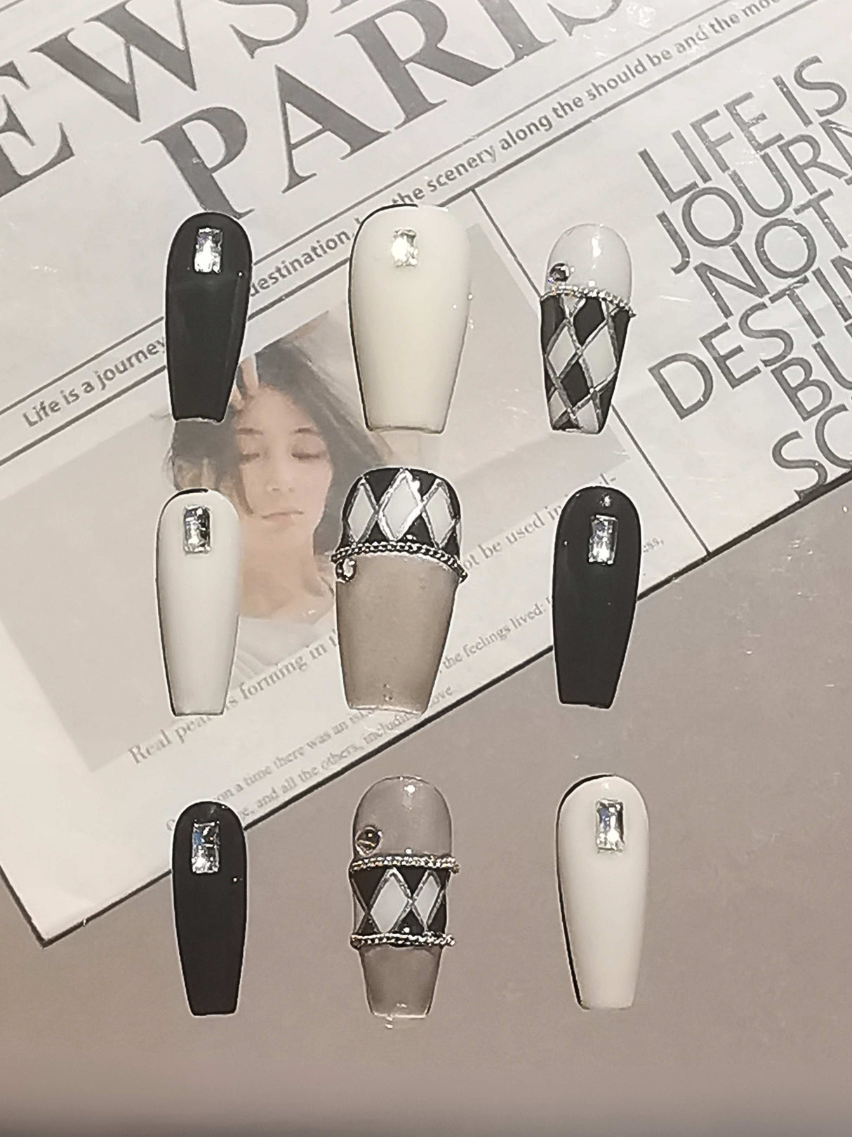These long, stiletto or coffin-shaped nails with color blocking, rhinestones, metallic bands, and matte/glossy finishes are perfect for a modern and stylish look
