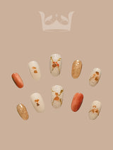 These press-on nails are for natural and fancy aesthetic enthusiasts. They have a minimalist design with unique patterns, an earthy color, and gold foil accents.