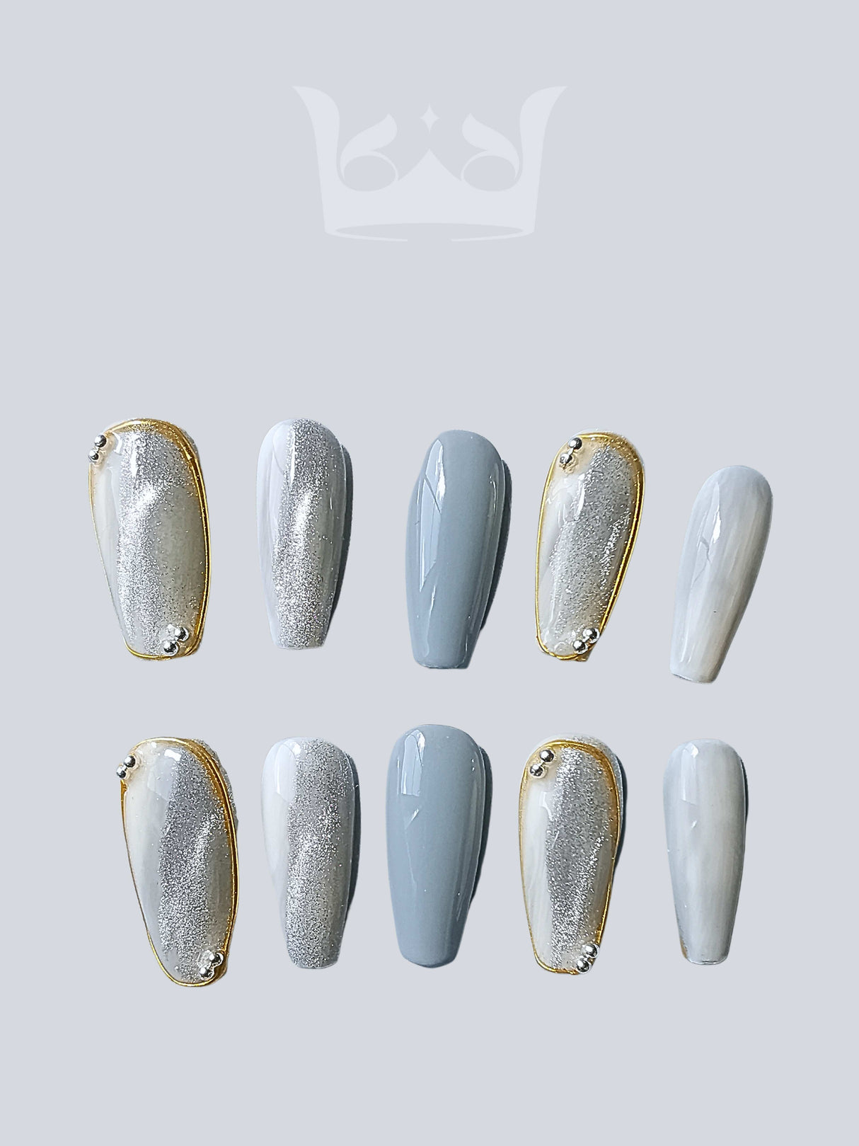 Sophisticated and modern nails with metallic silver and pastel blue colors, suitable for fashion events or personal style. Gold accent adds elegance.
