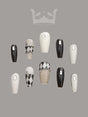 Luxurious and high-fashion-inspired nails with black, white, and gold color schemes, 3D jeweled effects, chain and bow designs, pearls, and add a touch of luxury and sophistication to any outfit.