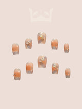 These press-on nails are perfect for special occasions, with a neutral base color and subtle embellishments that match a variety of outfits. They come in glossy finish for a polished look.