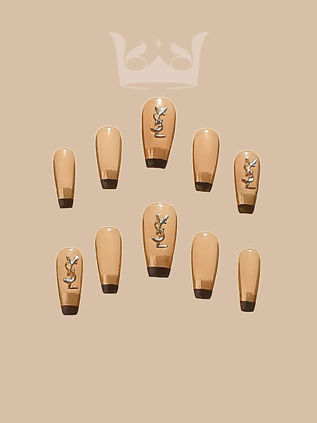 These press-on nails have a nude base color with metallic design, a squoval shape, and are suitable for formal occasions or to add a touch of sophistication.