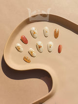 Cute nail tips with various colors, patterns, and accents like gold foil. Elegant and modern design for enhancing looks.