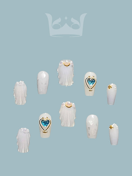 Cute nails for nail art designs, featuring glossy white finish, angelic motifs, heart-shaped jewels, and minimalist gold embellishments. Suitable for personal expression.