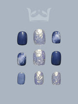 Navy blue press on nails with round nail tip. Featuring chrome, metallic color, marble painting, and squoval nail shape. Great design for summer nails.