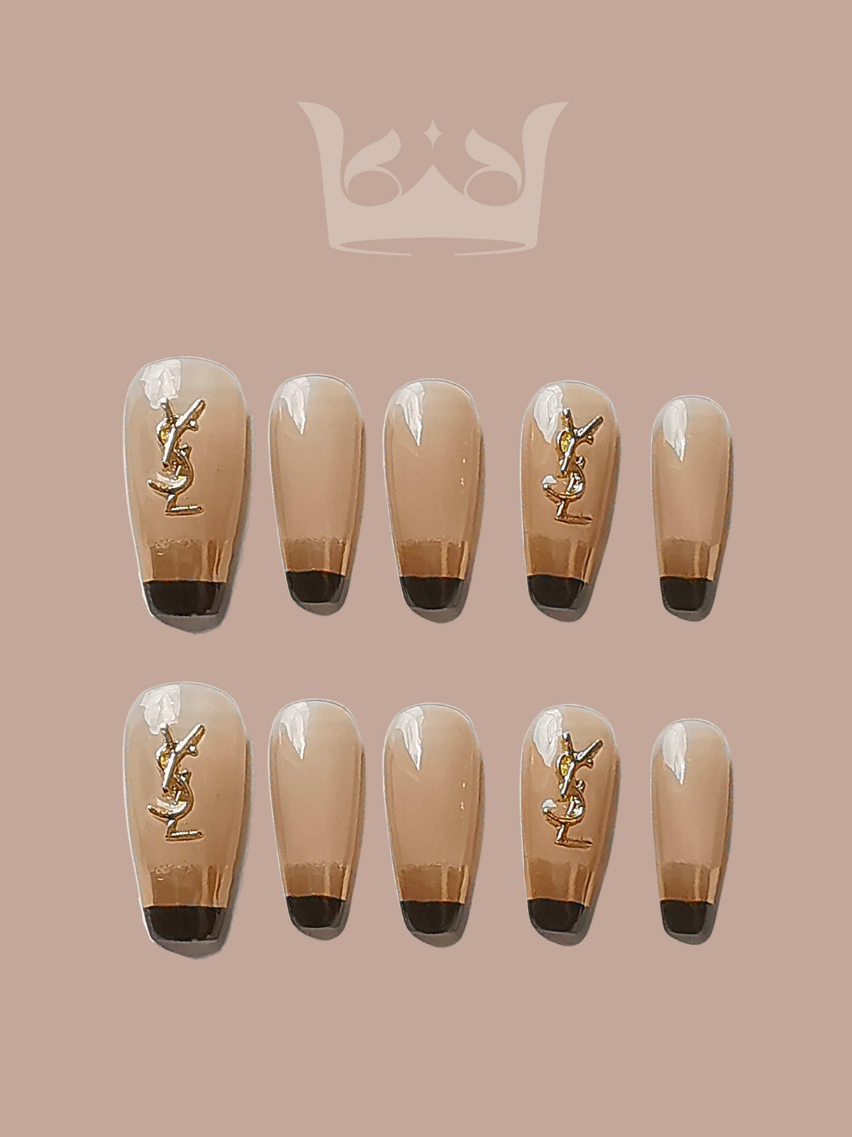 These press-on nails are for special occasions, with a nude base, black tips, and gold accents. They offer a fancy French manicure with a touch of luxury.