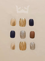 Stylish and modern nails with solid colors and metallic patterns in gold, silver, navy blue, copper, and nude tones for a trendy and fancy appearance.