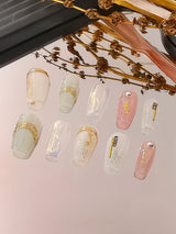 These press-on nails offer a creative and elegant design with pastel colors and gold foil accents suitable for formal events, parties, and everyday wear.